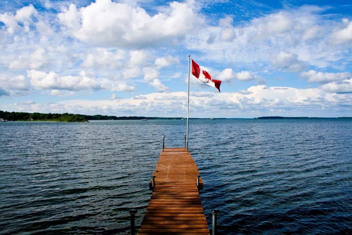Canadian flag in front of a lake