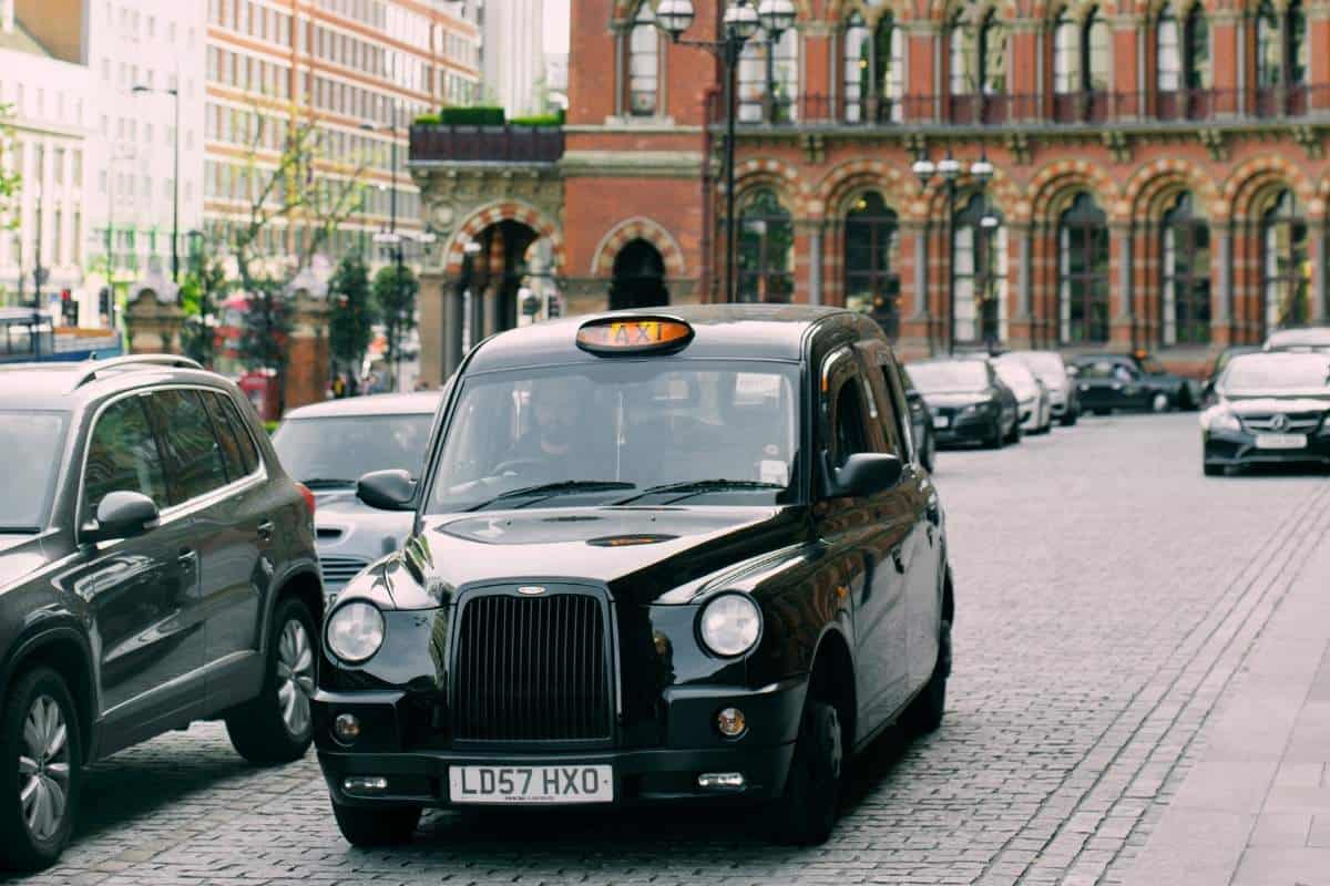 Traditional London Black Cab on cobblestone road