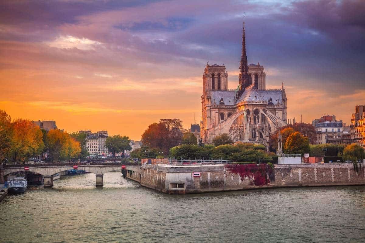 Cityscape image of Paris, France with the Notre Dame Cathedral during sunset