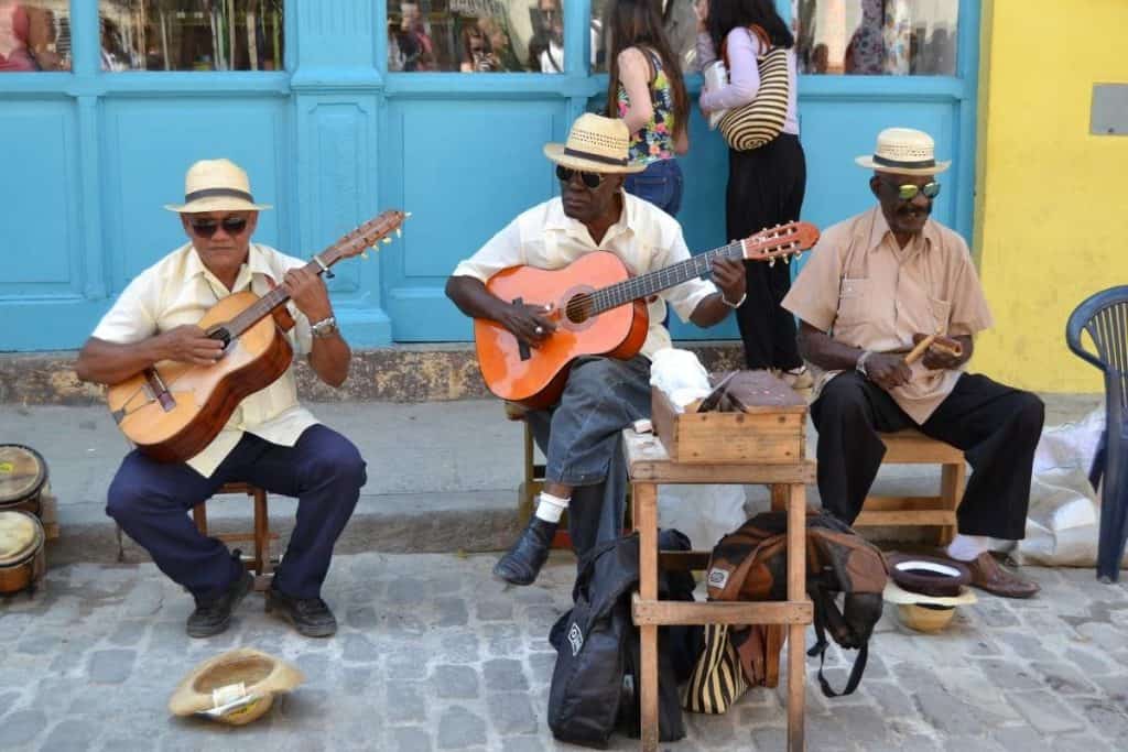 Three Cuban street performers playing instruments