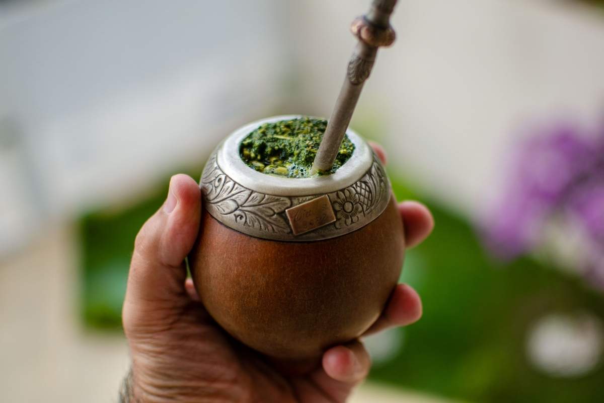 Hand holding a yerba mate, a traditional drink from Argentina
