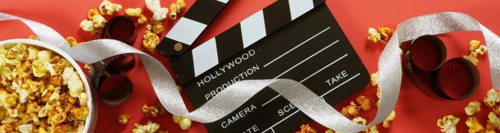 Movie background set with popcorn and film