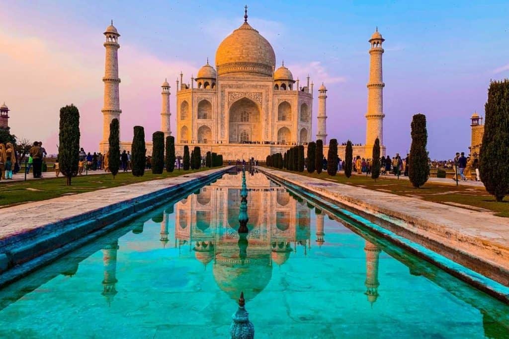 Taj Mahal in India at sunset with reflection in the water