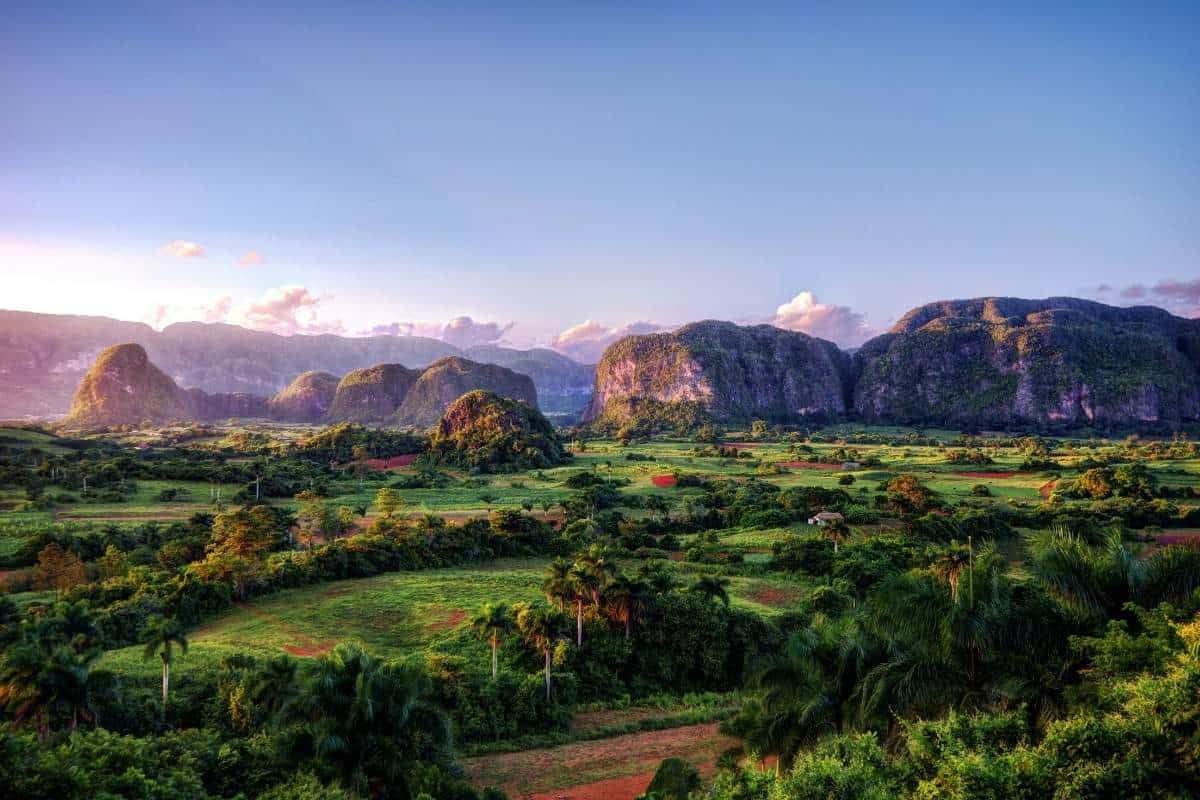 Landscape photo of the picturesque Viñales Valley in Cuba with green trees and a blue sky