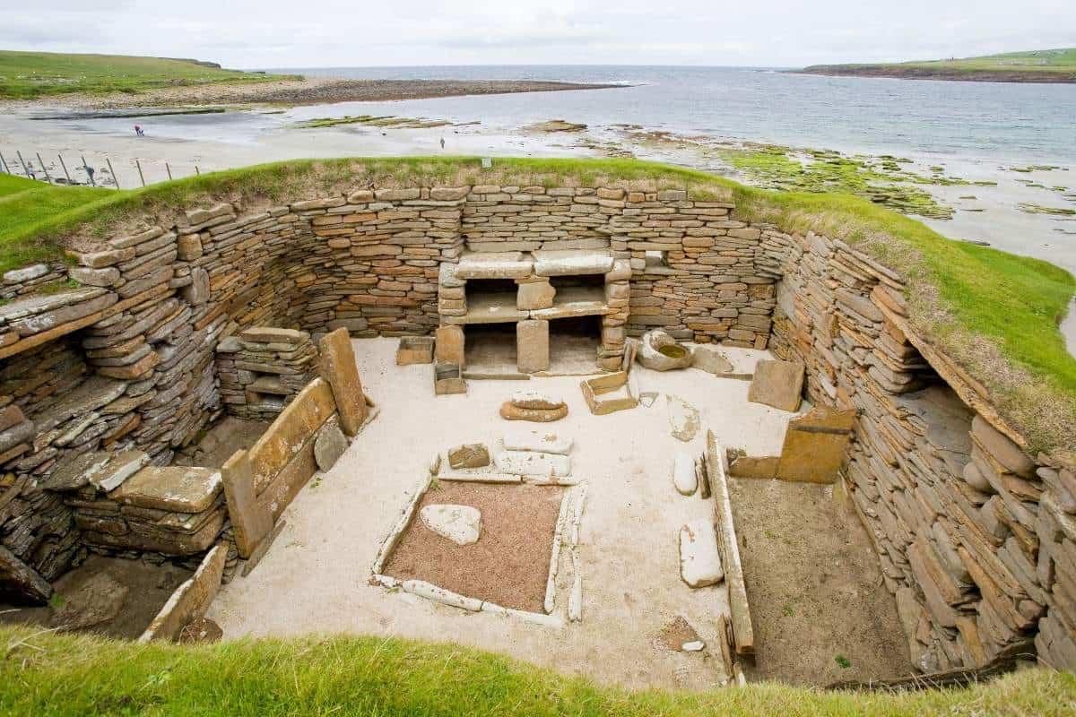 Top down view of ocean front ruins of Skara Brae in Scotland on a cloudy day