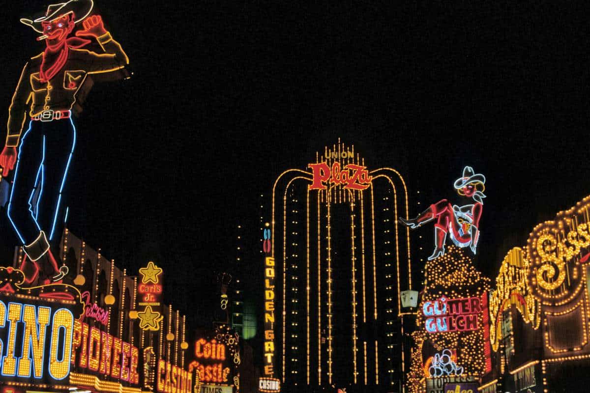 Various bright lights of casinos in Las Vegas lit up against a black sky background