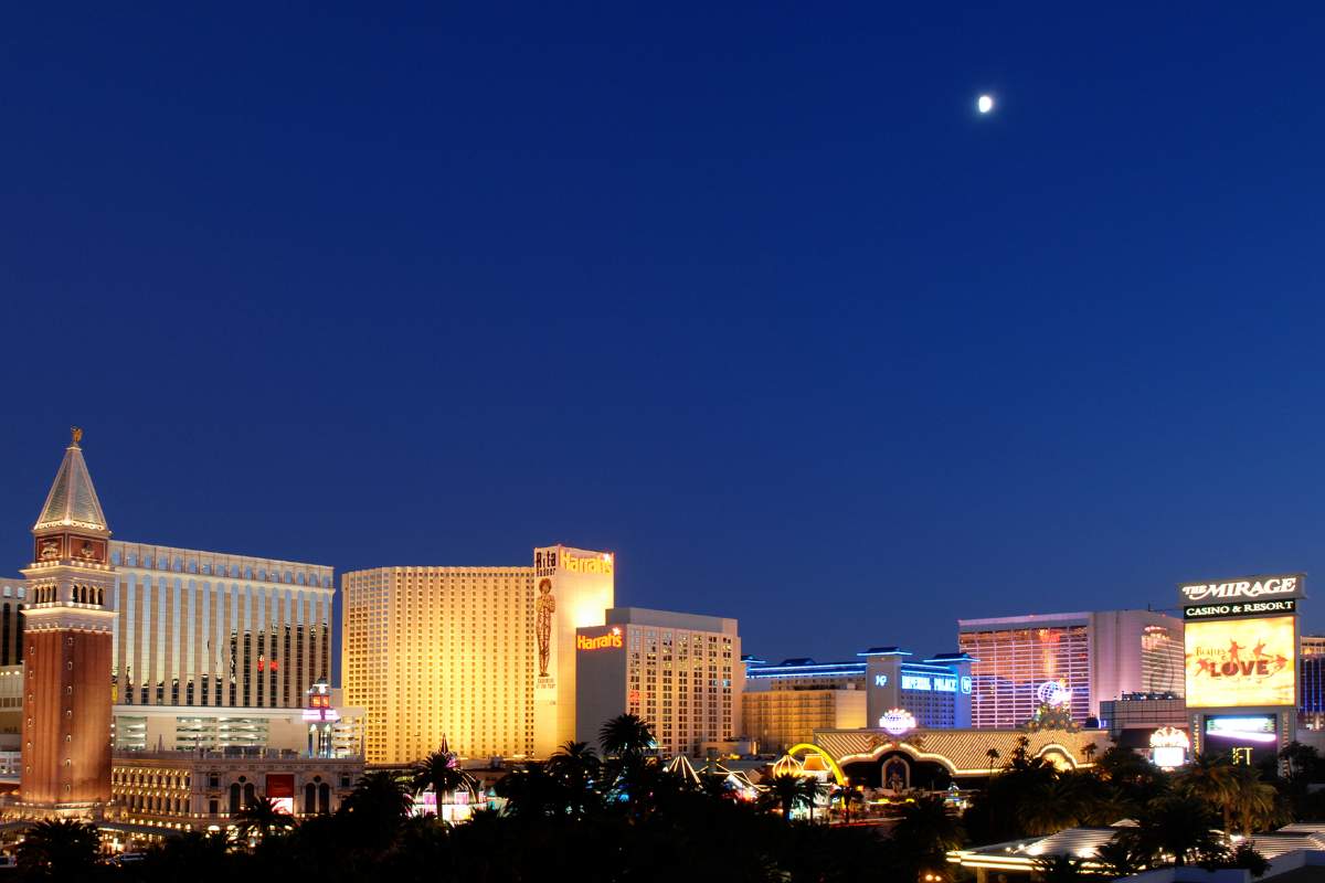 Panoramic shot of multiple resorts on the Las Vegas Strip on a clear night with the moon shining