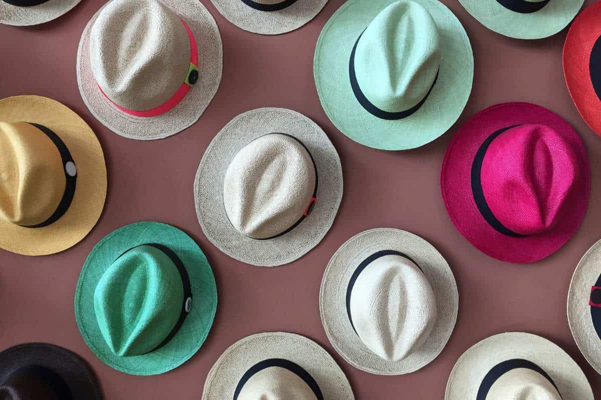 Various colorful Panama hats hanging on a wall
