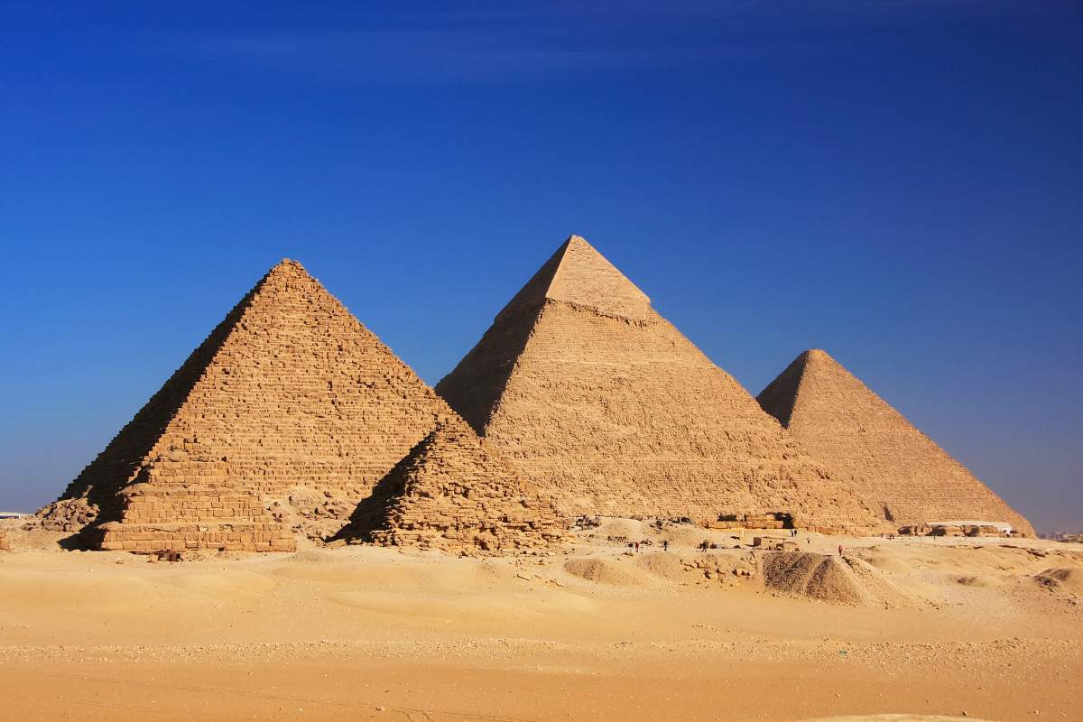The pyramids of Giza in Cairo, Egypt with a blue sky in the background