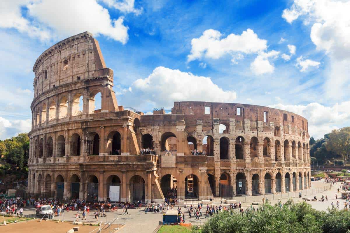 Aerial image of the Colosseum in Rome on a sunny day with blue skies and white clouds - one of the famous landmarks in Europe