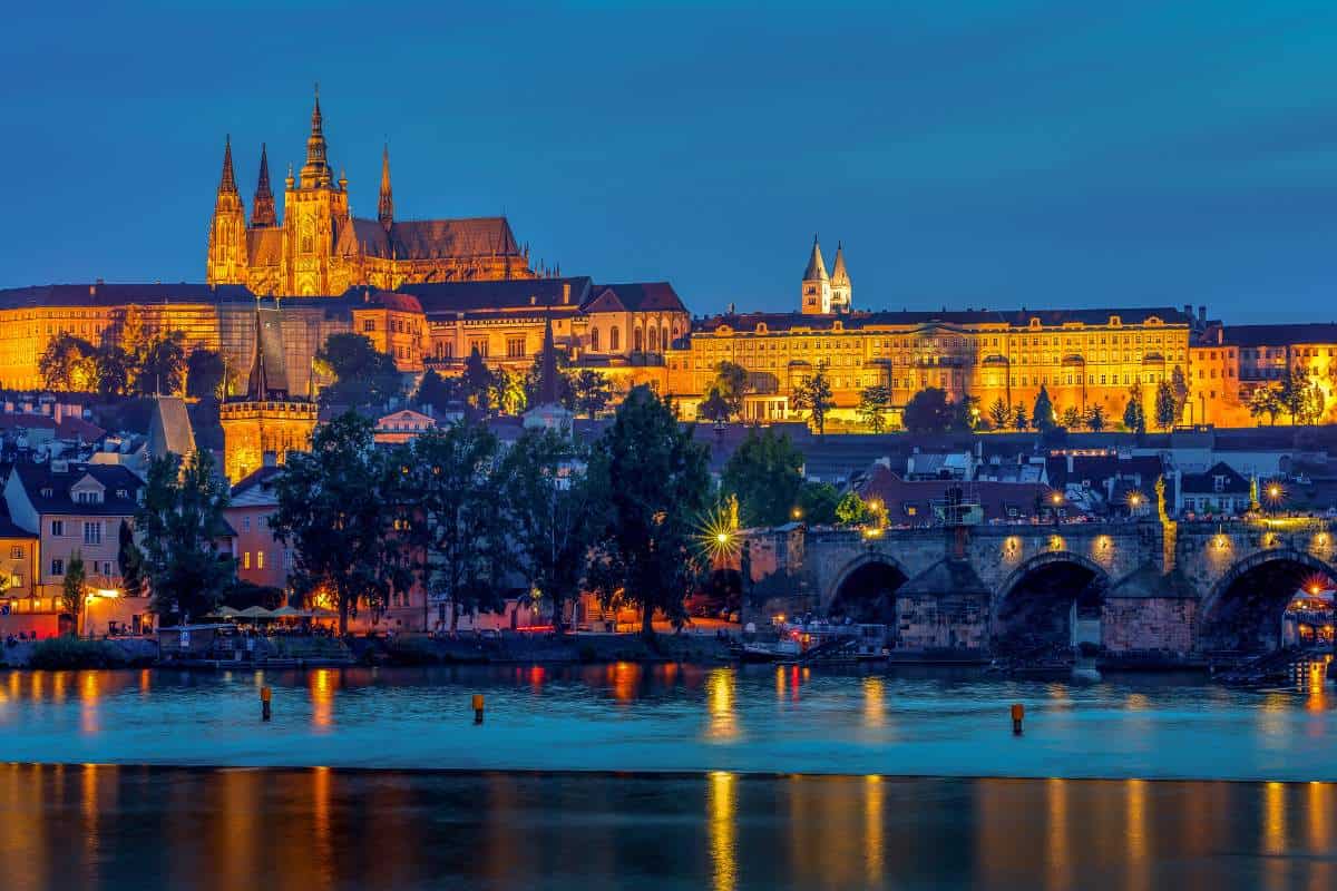 Reflection of illuminated lights of Prague Castle on the lake - famous landmarks in Europe.